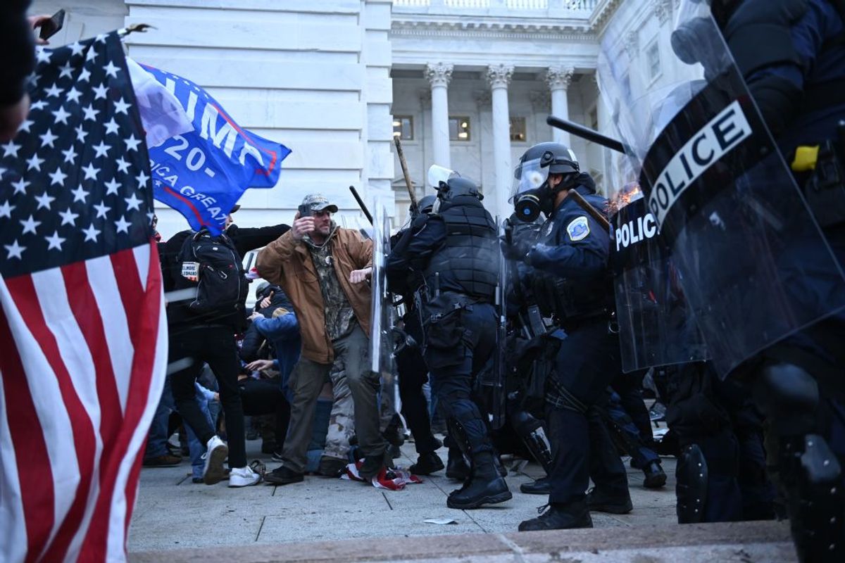 Trump supporters clash with police and security forces while outside the US Capitol in Washington, DC on January 6, 2021. - Thousands of Trump supporters, fueled by his spurious claims of voter fraud, flooded the nation's capital protesting the expected certification of Joe Biden's White House victory by the US Congress. (Photo by Brendan SMIALOWSKI / AFP) (Photo by BRENDAN SMIALOWSKI/AFP via Getty Images) (Getty Images)